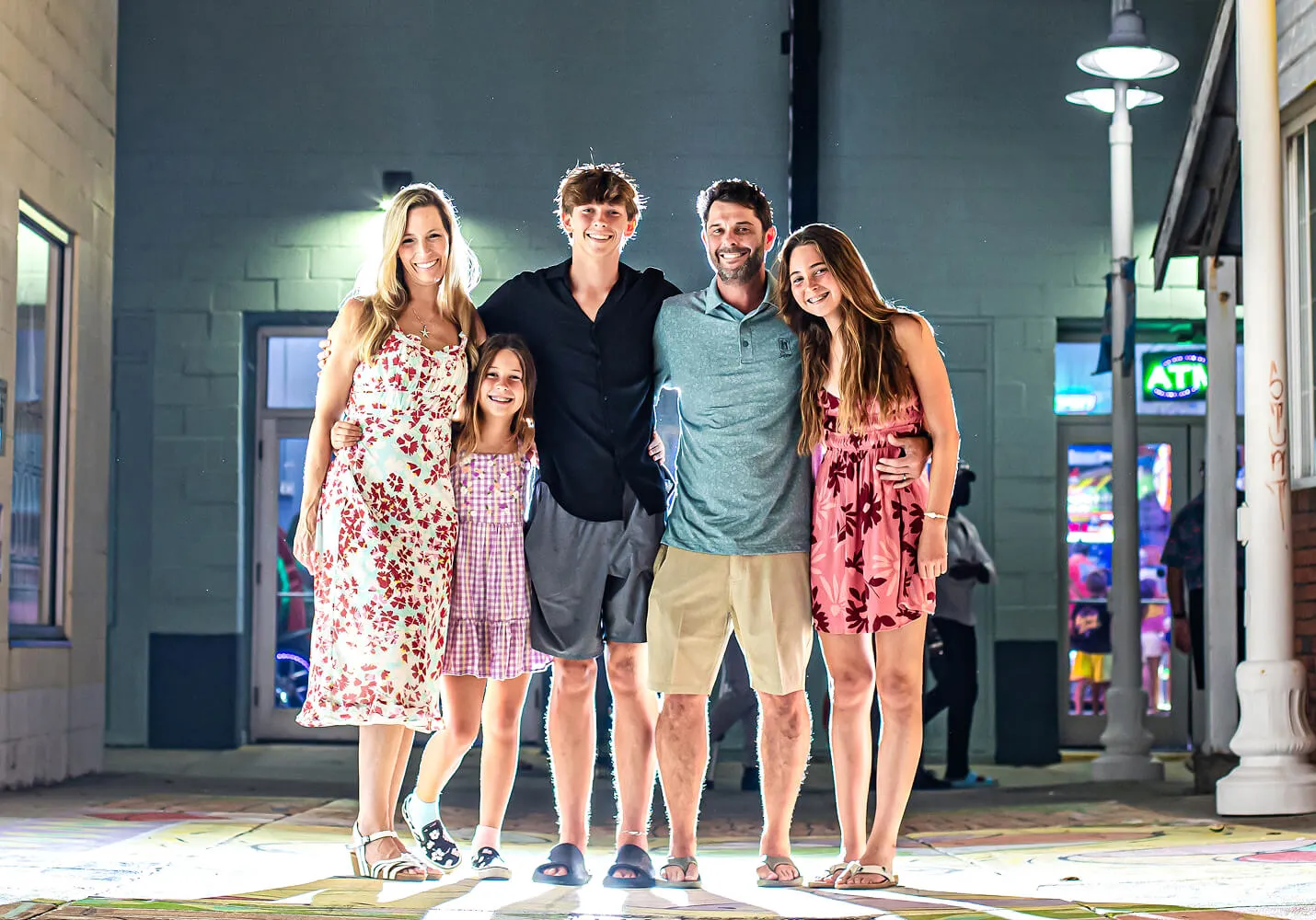 The Coastal Shield family outside the office at night